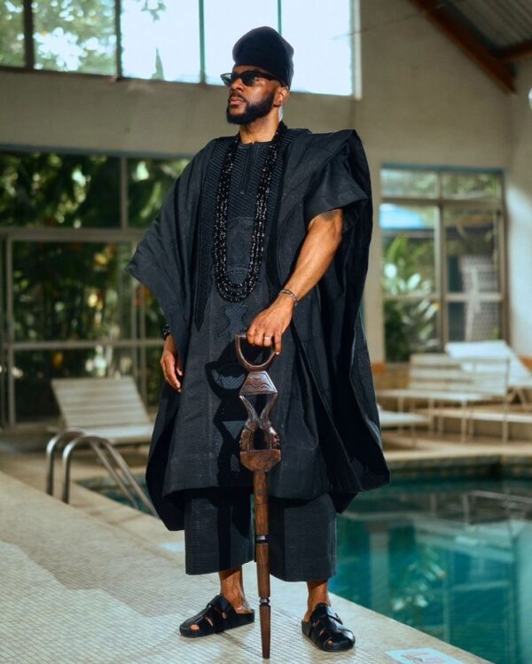 Ebuka Obi in Black Mini Agbada short sleeves with Native Staff