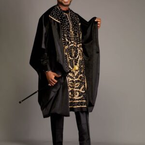 A happy African groom in a Black Agbada dress with his walking stick